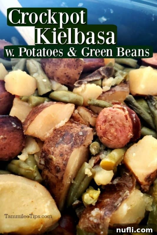 Crockpot Kielbasa, potatoes, and green beans cooking in a dark slow cooker bowl, ready to be served.