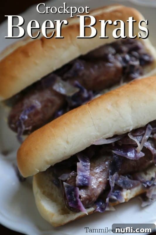 Savory Slow Cooker Beer Brats 2 Delicious Slow Cooker Beer Brats served on buns with onions and red cabbage, ready to eat