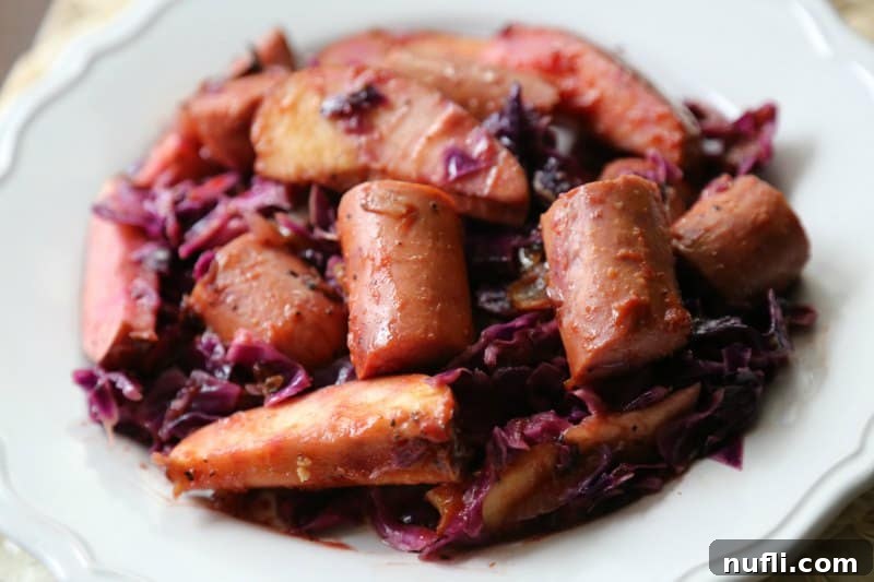 Crock Pot Kielbasa with Red Cabbage and Apples 3 white plate with cooked kielbasa, apples, and cabbage
