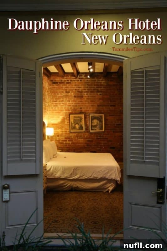 Dauphine Orleans Hotel New Orleans 2 Dauphin Orleans Hotel New Orleans looking through a double door to a bed and brick wall