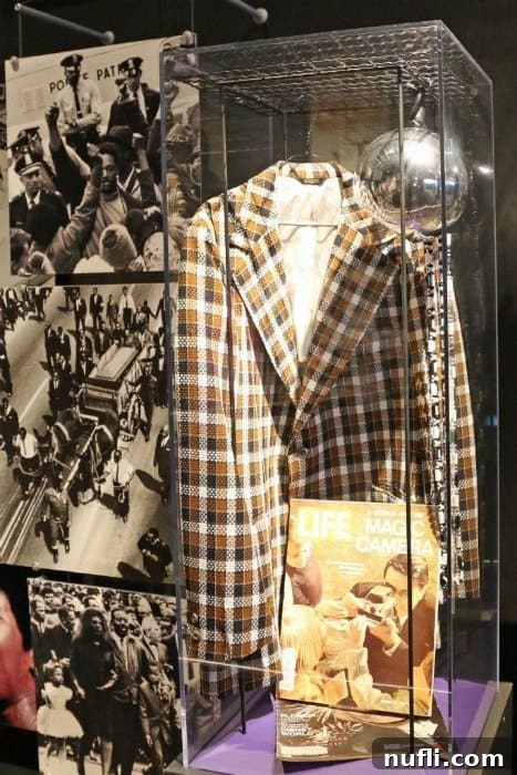 Gerald Fords clothes in a case next to photos