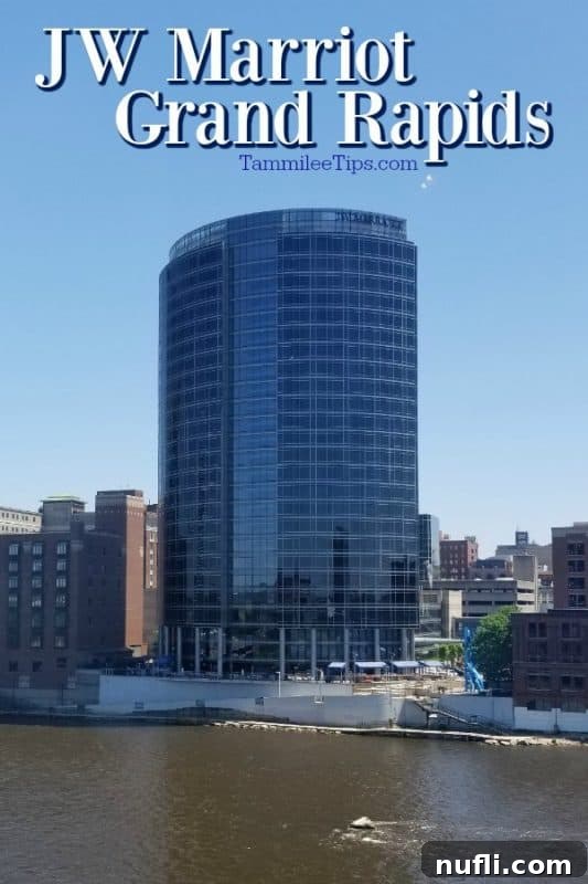 The stunning exterior of JW Marriott Grand Rapids, illuminated against the city skyline.