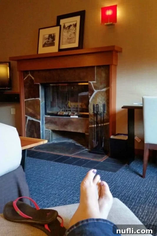 fireplace with the edge of the bed in the corner of the photo