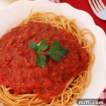 Homemade Olive Garden marinara sauce on spaghetti on a white plate