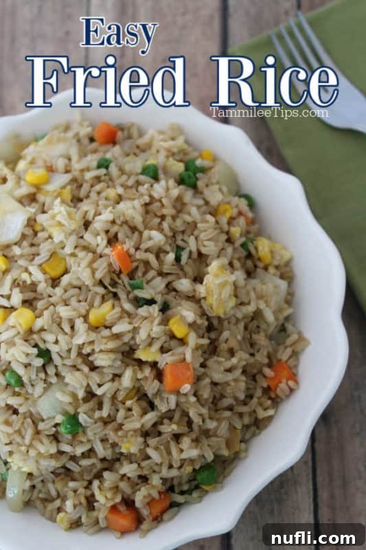 Easy fried rice over a bowl filled with rice and a fork 