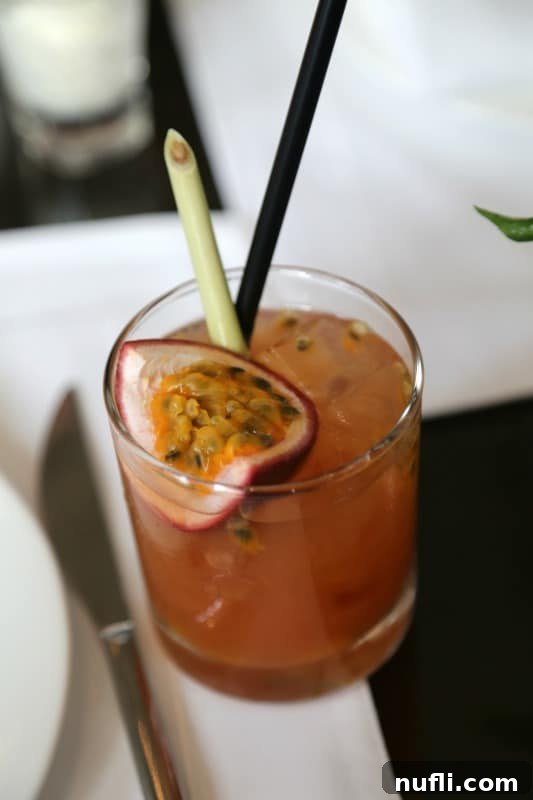 St. Regis Bangkok's Exquisite Afternoon Tea 5 A refreshing passion fruit cocktail, garnished beautifully and served in a stylish glass.