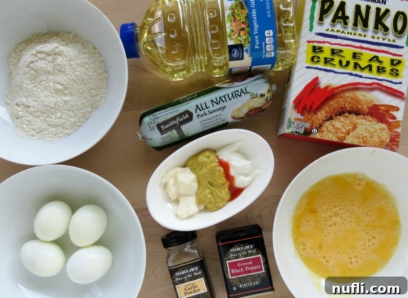 Ingredients for Scotch Eggs laid out on a table: panko bread crumbs, a raw egg in a bowl, raw ground pork sausage, a bottle of vegetable oil, and various seasoning shakers.