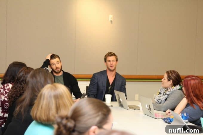 Chris Hemsworth and Chris Evans Discuss Avengers Age of Ultron 7 Chris Hemsworth and Chris Evans laughing together during the interview.