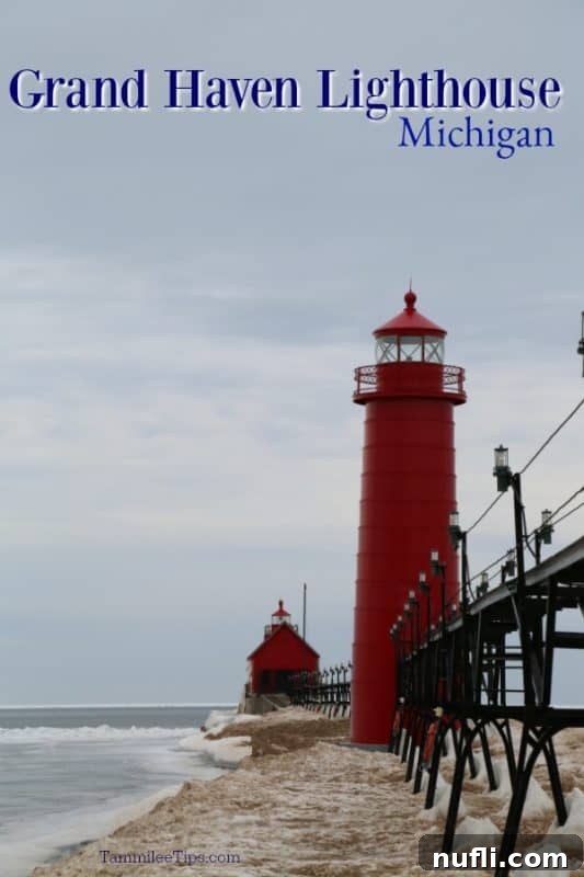 Grand Haven Lighthouse, Michigan standing tall and red amidst a landscape of ice and snow, with Lake Michigan's frozen expanse in the background.