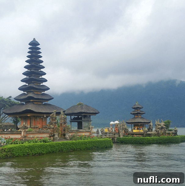 Balinese temples on a lake with clouds overhead