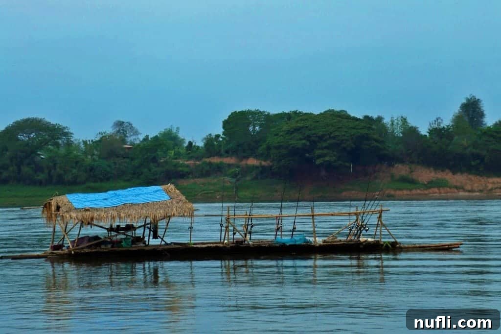 A large fishing barge with a distinctive yellow roof on the Mekong River