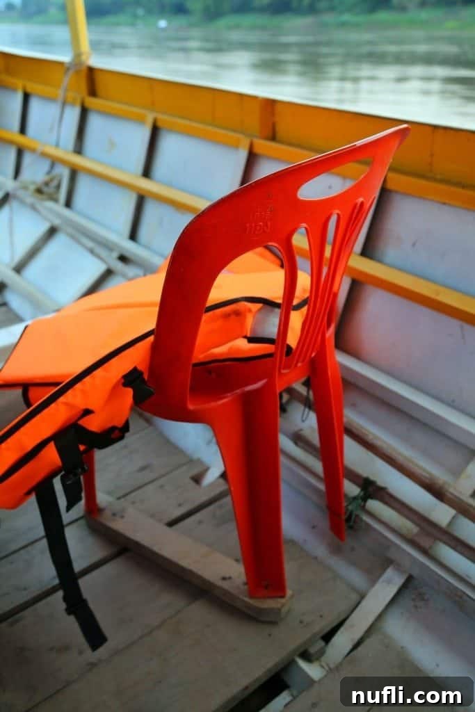 Plastic lawn chairs serving as seats on a Mekong River boat