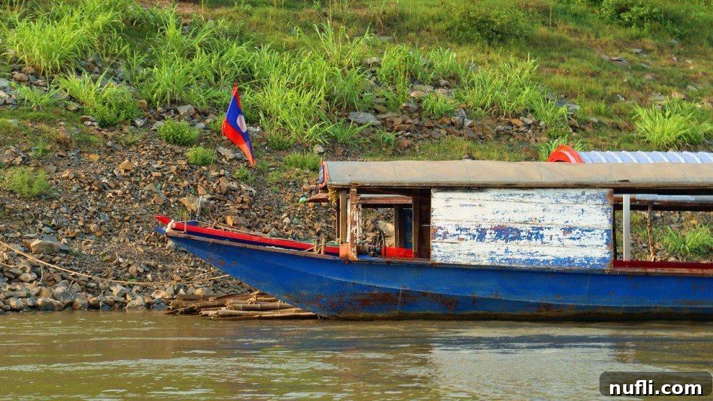 A longtail boat gracefully cruising along the tranquil Mekong River