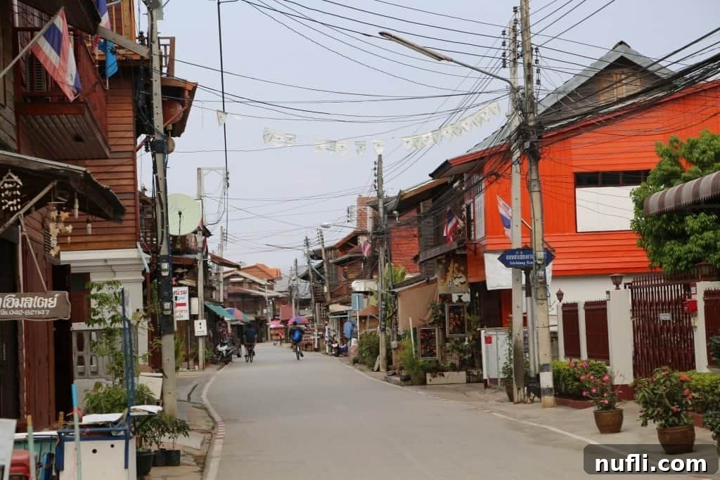 Chiang Khan Thailand's vibrant main street, a blend of old wooden houses and lively shops.