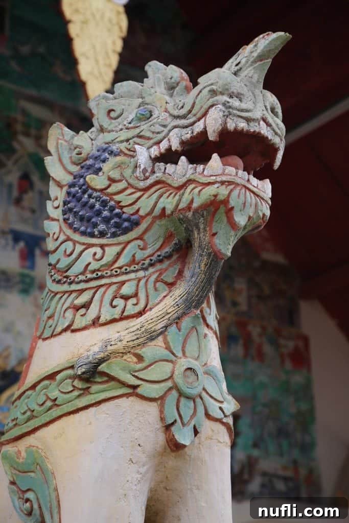 A majestic temple guard statue, standing sentinel at a sacred site in Chiang Khan.