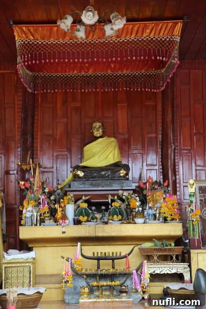 A golden Buddha statue radiating tranquility, a central figure in a Chiang Khan temple.