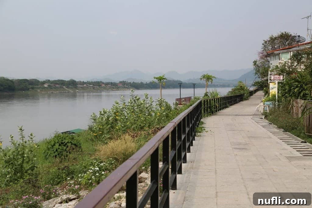 A panoramic view of the serene Mekong River as it flows past Chiang Khan, Thailand.
