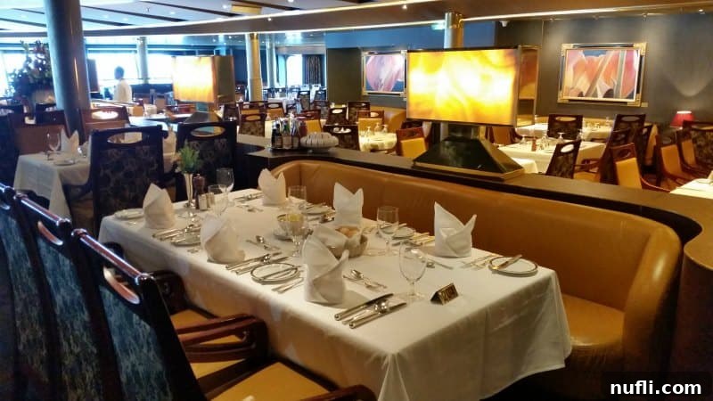 Elegantly set table with fine place settings in the ship's grand main dining room, ready for service