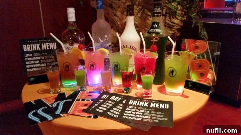 Table adorned with a selection of vibrant Holland America cocktails and drink menus in the B.B. King Blues Club, showcasing the ship's beverage offerings.