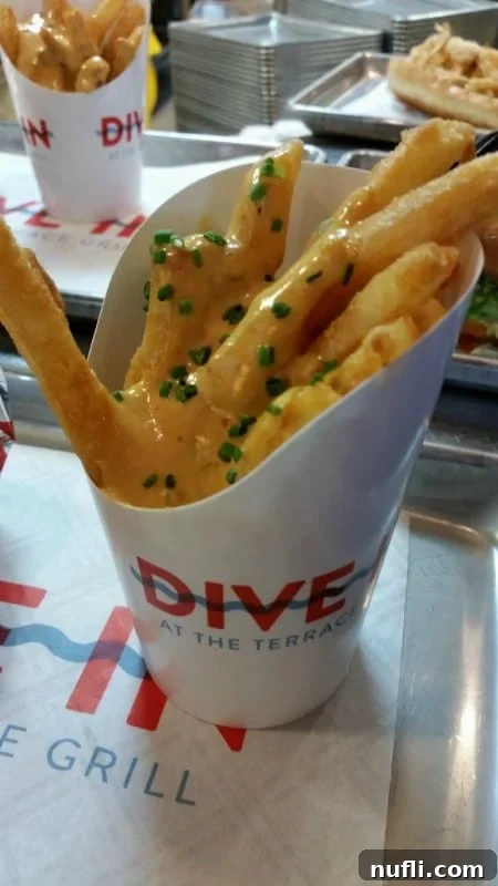 Irresistible golden fries generously covered in rich, melted cheese sauce