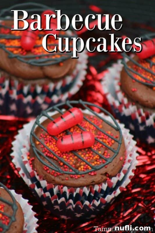 A tray of meticulously decorated Barbecue Hot Dog Cupcakes, designed to look like a mini BBQ grill with hot dogs and flames, perfect for summer parties.