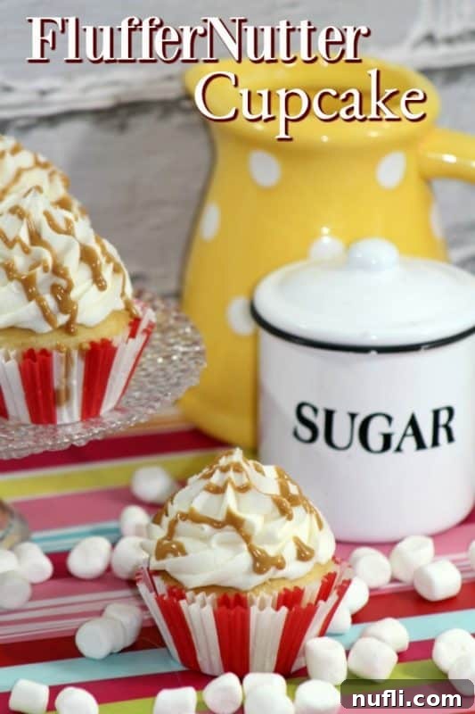 Peanut Butter Marshmallow Cloud Cupcakes 2 Two irresistible Fluffernutter Cupcakes next to a jar of marshmallow fluff, inviting you to bake this delightful treat.