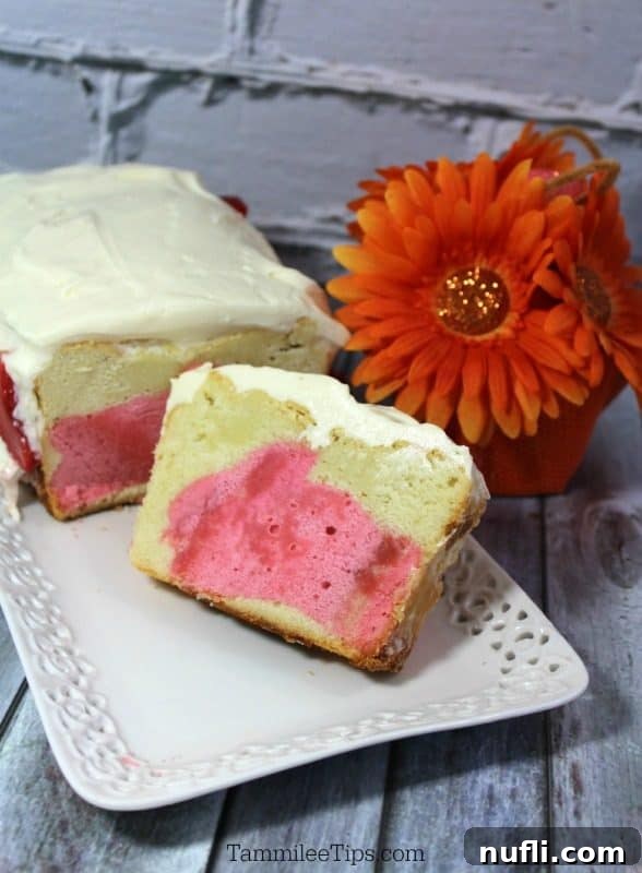 A beautifully sliced Easter Bunny Pound Cake on a pristine white platter, revealing its vibrant pink bunny center, ready to be served at a festive gathering.