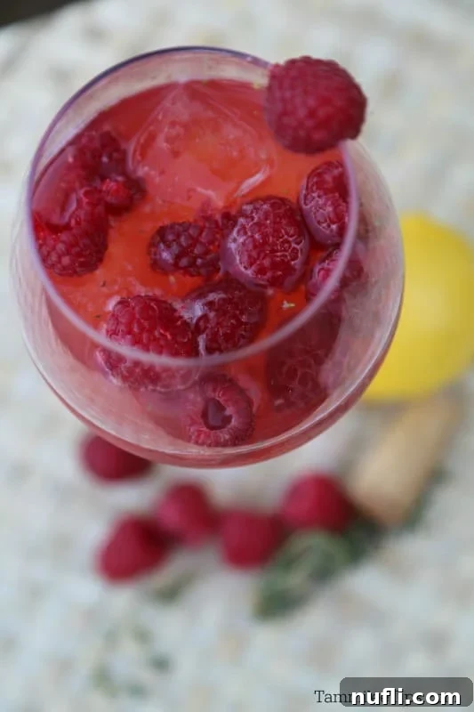 Red moscato cocktail with raspberries in a wine glass