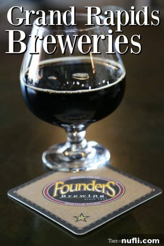 Glass of craft beer with a Founders coaster, symbolizing Grand Rapids breweries