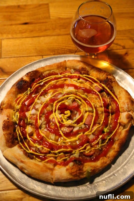 Westerdog pizza, featuring hot dogs on a pizza base, from Mitten Brewing Co.