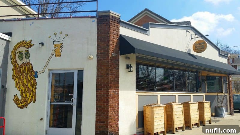 Exterior of Harmony Brewing Company with a vibrant mural featuring a man with a hops beard