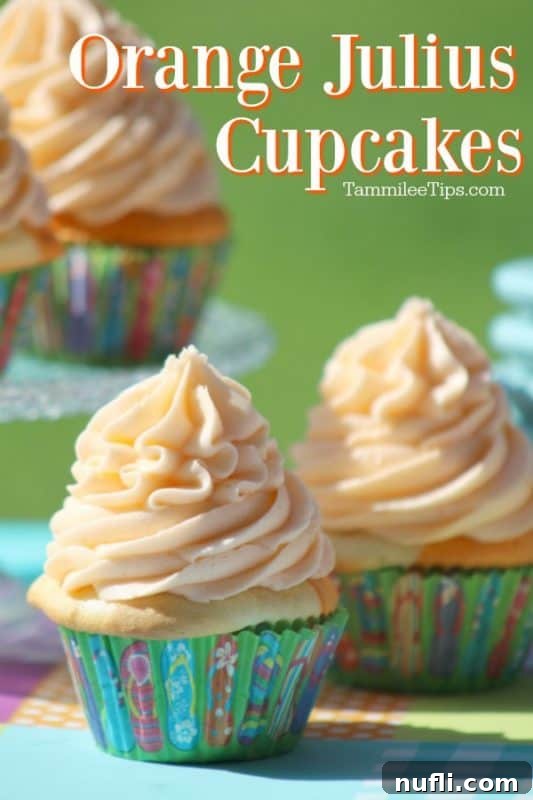 Vibrant Orange Julius cupcakes artfully arranged on a rustic wooden table, ready for a sweet celebration.
