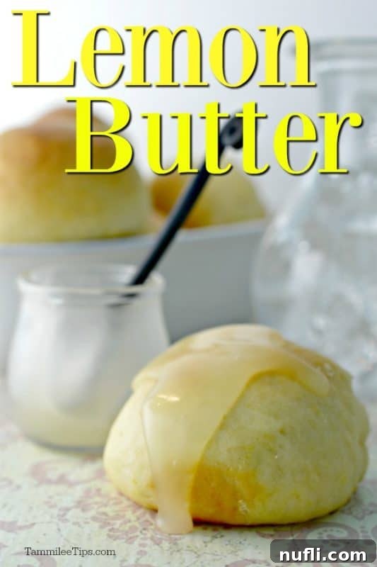 Lemon butter spread generously over a warm roll, with a jar of lemon butter in the soft background.