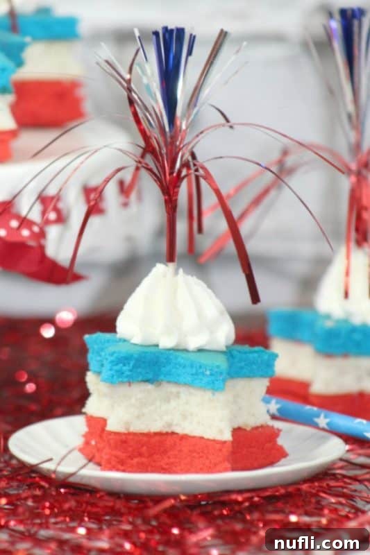 Festive Red, White, and Blue Star Cupcakes adorned with patriotic decorations, perfect for Fourth of July celebrations.
