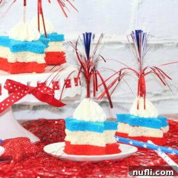 Close-up of Firecracker Red, White, and Blue Cupcakes on a tiered cake stand, showcasing their festive star shapes and frosting.