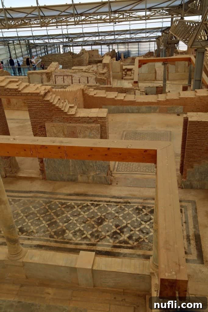 Looking into an excavated room within the Terracotta Houses, showing historical layers.