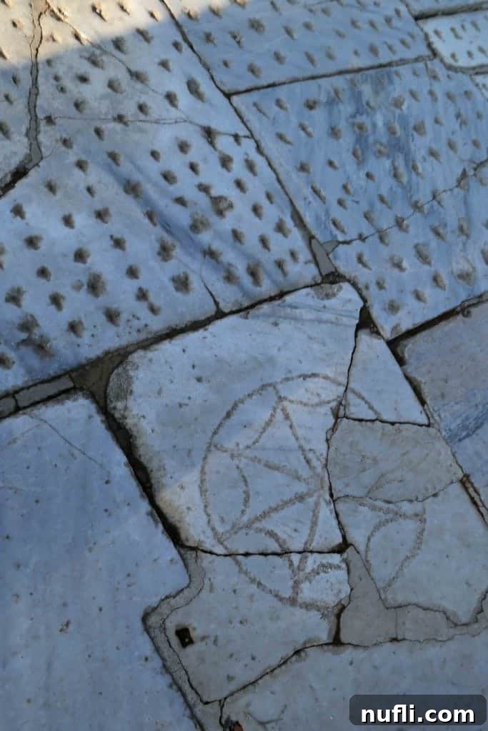 Close-up of vibrant mosaic block patterns forming a walkway in ancient Ephesus, showcasing detailed artistry.