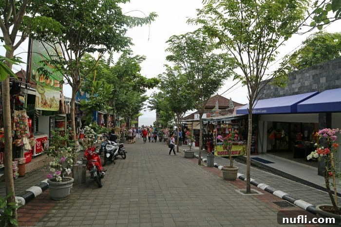 Pathway leading to Tanah Lot Temple lined with various Balinese souvenir shops and food stalls