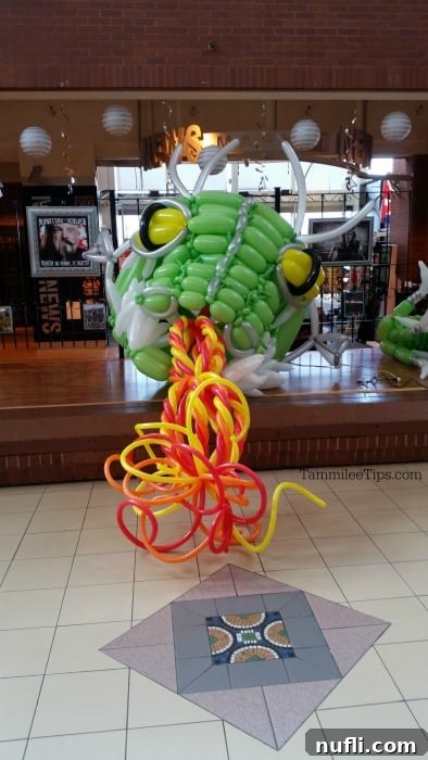 A large, colorful balloon dragon sculpture being constructed in Market Square, adding a whimsical touch to the urban landscape.