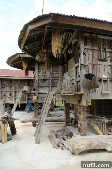 Exploring Thai Dam Heritage Village in Loei 3 raised houses made with wood with things attached to the side