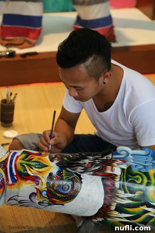 Gentleman painting a Phi Ta Khon mask